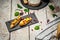 Antipasti snacks for Wine. Brushetta with mango, Camembert cheese and pomegranate served on a shale board, rustic wooden table.