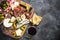 Antipasto board with sliced meat, ham, salami, cheese, olives an