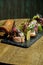 Antipasto - bruschetta with light-salted sprat or herring, feta cheese on a French baguette on a stone tray. Close up, selective