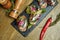 Antipasto - bruschetta with light-salted sprat or herring, feta cheese on a French baguette on a stone tray. Top view, flat lay