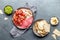 Antipasto. Meat platter, chips and sauces, red wine on gray background. Top view