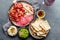 Antipasto. Meat platter, chips and sauces, red wine on gray background. Top view