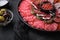 Antipasto platter cold meat with chorizo, fuet,salami, salchichon and longaniza on black textured background
