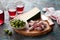 Antipasto Platter. Fuet mini sausages, green olives and cheese on wooden cutting board