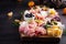 Antipasto platter with ham, prosciutto, salami, cheese, crackers and olives on a wooden background.