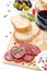 Antipasto - salami, bread, olives and glass of red wine isolated