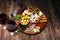 Antipasto various appetizer. Cutting board with prosciutto, salami, cheese, bread and olives on dark wooden background