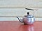 Antique Aluminum Kettle on wooden table.