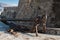 Antique anchor at walls of the Old town of Mediterranean city Budva