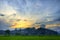 Antique Beautiful Landscape Cloud and Hill Cover the Sunset with Green Plants & Trees, Orange Sunlight, Blue White and Grey Sky