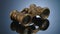 Antique binoculars on a reflective studio background