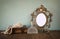 Antique blank Victorian style frame and old book with vintage pearl necklace on wooden table. retro filtered image