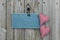 Antique blue sign hanging on wood door with hearts and iron keys