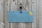 Antique blue sign hanging on wood door with hearts and iron keys