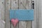 Antique blue sign on wood door with heart and iron keys