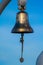 Antique brass ship bell blue sky background