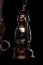 Antique bronze iron-shod chandelier isolated on black background. Close-up