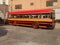 Antique bus of multiple colors parking without people on board