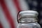 Antique canning jar with American flag background