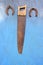 Antique carpenter hand saw and two horseshoe on wall