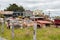 Antique cars on a big scrapyard at the end of Old Coach Road Trail, New Zealand