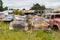 Antique cars on a big scrapyard at the end of Old Coach Road Trail, New Zealand