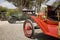 Antique cars parked in an orange grove