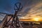 Antique catapult in Alghero seafront at sunset