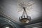 Antique chandelier on the ceiling in an old abandoned manor house.