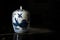 Antique Chinese porcelain jar in an auction against a black background. Empty copy space
