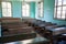 Antique classroom with empty wooden desks and benches