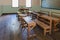 Antique classroom in school with Rows of empty wooden desks