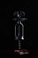 Antique corkscrew hanging in the air on a black background. An ancient corkscrew levitates and leaves circles on the surface of th