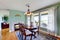 Antique dining area with wooden table set, hardwood floor and rug