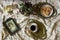 Antique dishes on a table with a checkered tablecloth, nearby are old paintings