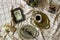 Antique dishes on a table with a checkered tablecloth, nearby are old paintings