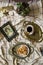 Antique dishes on a table with a checkered tablecloth, nearby are old paintings