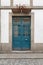 Antique door on building facade made of wood wrought iron and glass. Modernist architecture