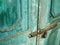 Antique door with chipped blue paint and rusted lock