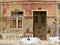 Antique door in a house with worn stone wall texture.