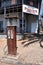 A antique double petrol bowser standing outside the historic 1908 Peeramon Hotel.