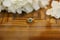 Antique emerald ring and white flowers on the table