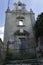 antique facade ruins of SS Trinita church in middle of milazzo town with blue sky