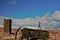 Antique farm equipment and water tower in front of snow capped mountains