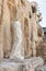 An antique female headless statue in white marble is in the ruins of Caesarea Fortress on the Mediterranean coast near Caesarea