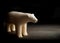 Antique figure of polar bear made of walrus tusk on black background