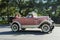 Antique Ford Roadster, young women having fun in pink Ford Roadster, Havana, Cuba