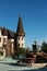 Antique fountain in the garden of the old castle. Stone walkway. Alley in beautiful garden with flowers and trees around. Summer