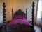 Antique four-poster bed with headboards carved inside Villa dei
