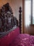 Antique four-poster bed with headboards carved inside Villa dei